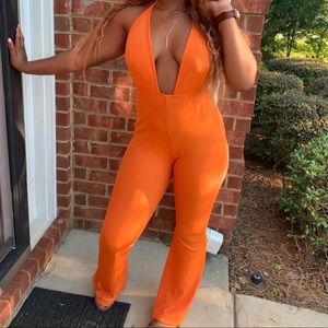 Orange bandage plunge flare leg jumpsuit